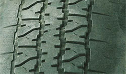 Underinflated tires (edge of tread worn)