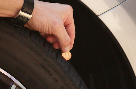 tire tread depth gauge with a coin